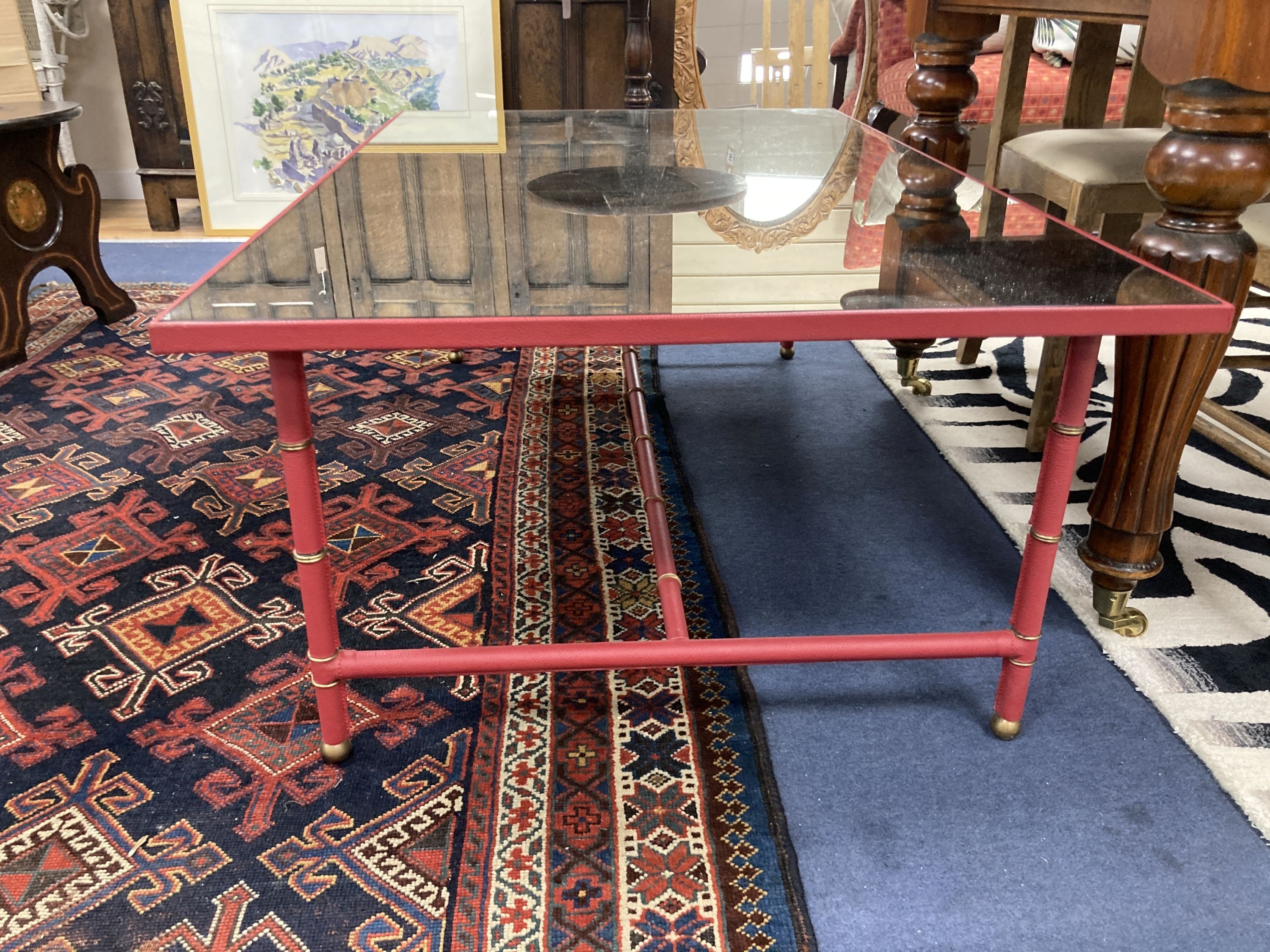 A Julien Chichester 'Richter' stitched leather mirrored coffee table. W-130, D-80, H-46cm.